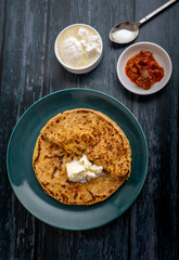 stuffed dal paratha with curd, pickle and white butter 
