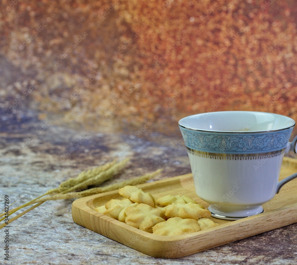 Wall mural butter cookies with milk and tasty and delicious beverages are placed on wooden trays to serve consu