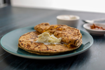 stuffed dal paratha with curd, pickle and white butter 