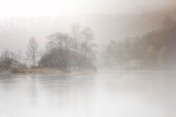 Obraz na płótnie Canvas Foggy Islands on the River