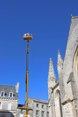  Cherry picker working on Notre Dame Church, Fontenay-le-Comte, France