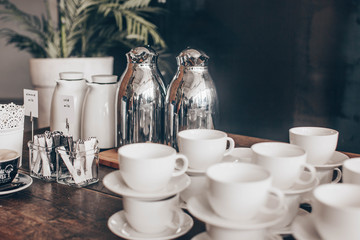 Stacked empty teacups with teaspoons at a function over