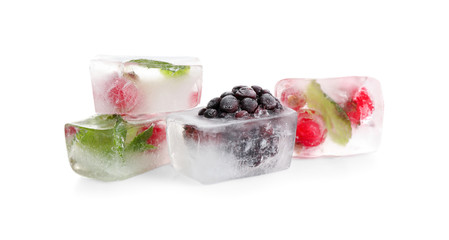 Ice cubes with berries and mint on white background