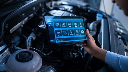 Car Service Manager or Mechanic Uses a Tablet Computer with a Futuristic Interactive Diagnostics...