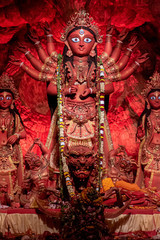 Idol of Goddess Devi Durga at a decorated puja pandal in Kolkata, West Bengal, India. Durga Puja is...