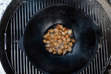 Pieces of lamb with onion are fried in boiling oil on the fire. As a stage in the preparation of...