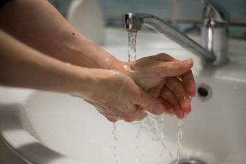 COVID-19 Coronavirus prevention thorough washing hands with antibacterial soap in the bathroom after visiting public places - 341431001
