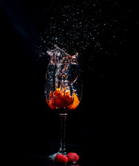 Splashing fruits in to glass of water