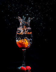 Splashing fruits in to glass of water