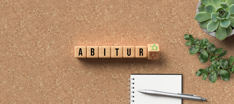 cubes with the German name ABITUR as university-entry qualification and thumbs-up or thumbs-down decision on cork background