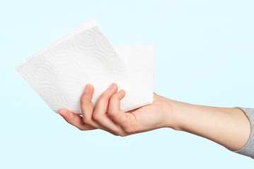 A paper napkin or paper towel in a woman 's hand. Concept of hygiene, infection prevention, coronavirus