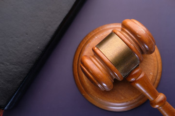 Close up of gavel, book on black background 