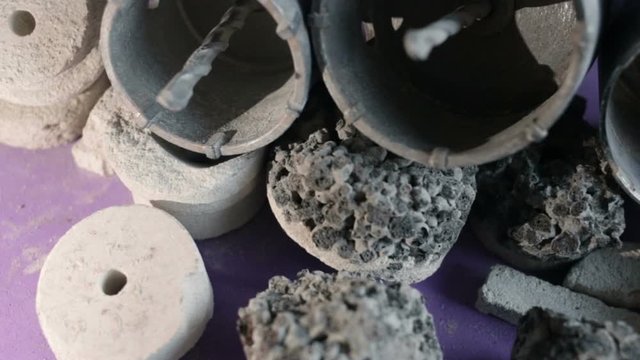 Construction debris (expanded clay, gas silicate, concrete) and crowns for installation of junction boxes, sub-cabinets. Close-up, real time, low depth of field