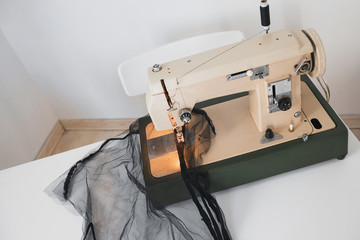 Sewing process of mesh fatin on the sewing machine at home in the workplace on a white background
