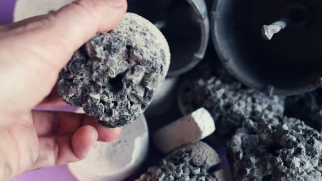 Someone puts a multi-layer drill sample in the crown for drilling hard rocks of stone, concrete, and other building structures. Close-up, real time, contains people