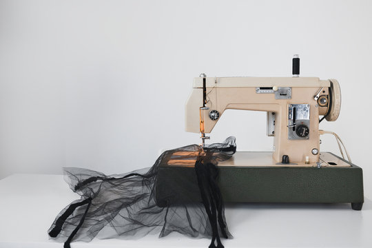 Sewing process of mesh fatin on the sewing machine at home in the workplace on a white background