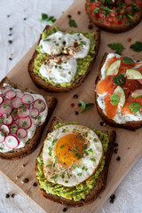 Set of aperitif sandwiches with avocado, egg, salmon ...

