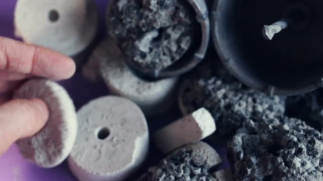 Gas silicate medal with a hole in the center (drill sample, centre mark, stippler, borehole sample, kern) - a product of construction electrical work (for junction boxes and sub-cabinets). Real time, 