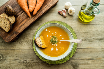 Top view of carrot soup with bread - Food and healthy lifestyle concept - Main focus on soup
