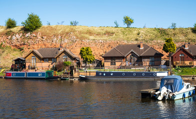 Fototapeta premium Riverside chalets and moored boats