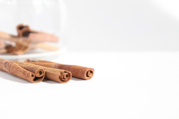 cinnamon sticks are on the table on a white background there is a place to insert text
