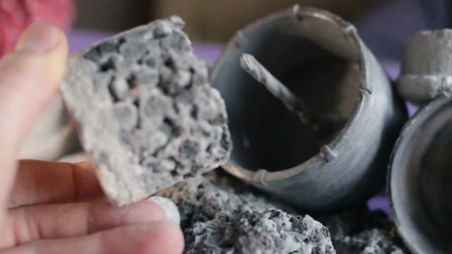 Someone's hand pulls the core from the crown for drilling solid concrete, silicate, expanded clay. Close-up, real time, contains people