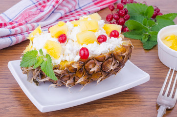 Fresh homemade cottage cheese with red berries and pineapple.