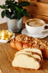 Freshly baked bread with variety of toppings on a wooden tray in casual dine in table background with coffee latte. And cheese cubes. Authentic Mediterranean cuisine photography concept.