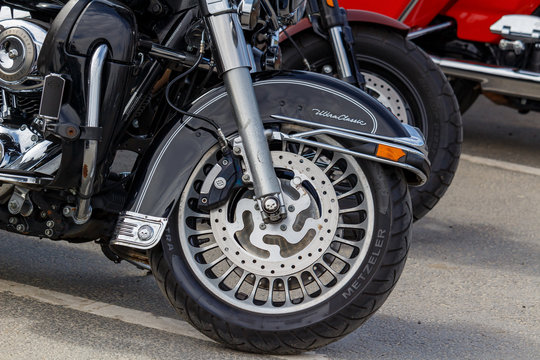 Moscow, Russia - May 04, 2019: Front wheel with black front fender of Harley Davidson motorcycle closeup