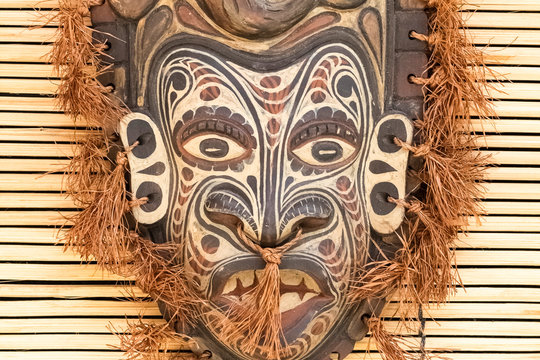 Detail of a painted, wooden mask for rituals. Closeup