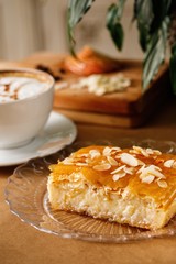 Greek special sweet pie with creamy custard, vanilla and fill soaked aromatic syrup. Authentic Mediterranean dish galaktoboureko plating photography.
