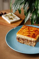 Traditional greek baked pasta dish made from layers of pasta, ground beed, topped with béchamel sauce sprinkled with greek elassano cheese. Authentic Mediterranean dish.