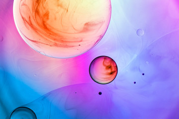 Abstract color background. Bubbles of oil in a colored liquid and lighting in macro photography. Creative and art concept