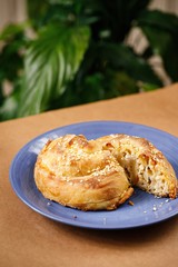 Greek pastry puff with white sesame seeds in wooden background. Authentic Mediterranean cuisine food photography for book menu concept.
