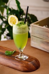 Healthy lemon mint fresh juice on elegant glassware in a wooden background. Authentic cuisine beverage options on menu.