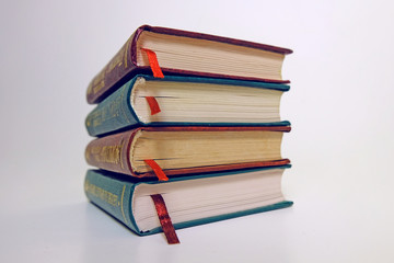 Book stack on a white background with bookmarks on classic, vintage style