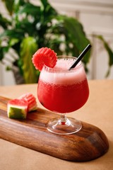 Healthy watermelon fresh juice on elegant glassware in a wooden background. Authentic cuisine beverage options on menu. - 341441021