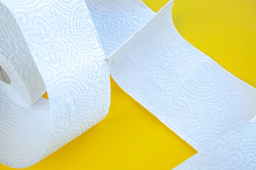 coronavirus a lot of toilet paper on a yellow background
