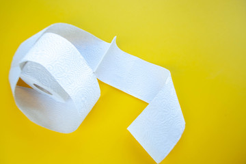 coronavirus a lot of toilet paper on a yellow background
