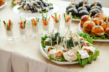 Catering, buffet at the event with various snacks.