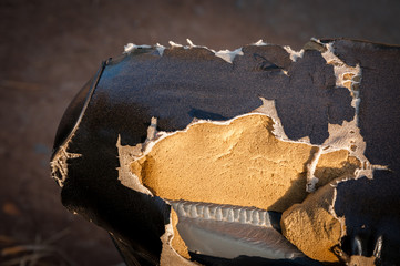 Old Leather seat.Broken leather.Closeup of old black leather motorcycle seat damage.