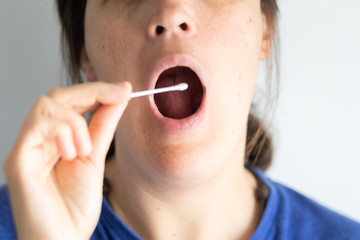 Doctor getting saliva test sample in clinic hospital