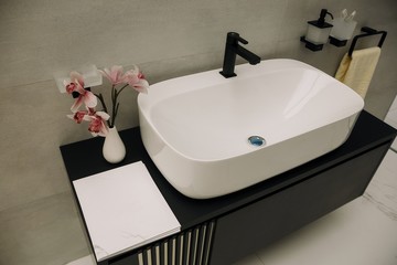 Modern square sink in the bathroom. Stylish vessel sink under mirror in bathroom. Interior element