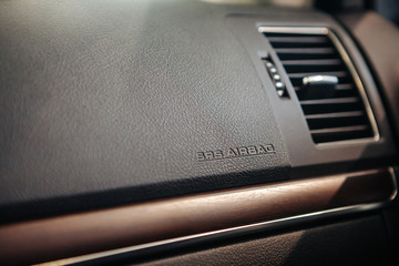 Closeup of airbag cover on auto dashboard.