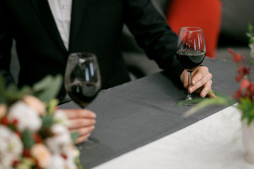
couple drinks wine from glass goblets. Wedding