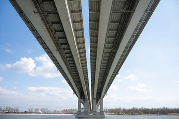 bottom view of a huge bridge over a river