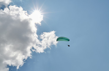 A paraglider is flying in the sky. Paraglider flying during an extreme sports event. Bottom view.