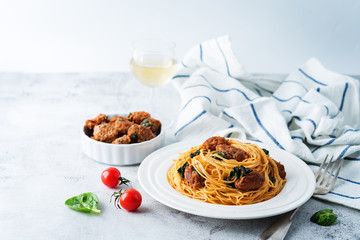 Tomato Spinach Sausage Pasta in a white plate