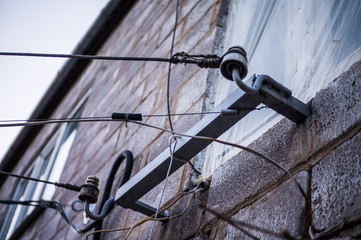 The bracket attached to the house, conducts electricity to people for use.
