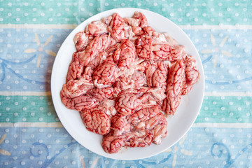 Pork raw brain in a white plate